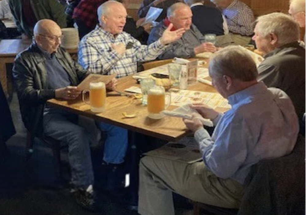 Group of retired men talking at a table